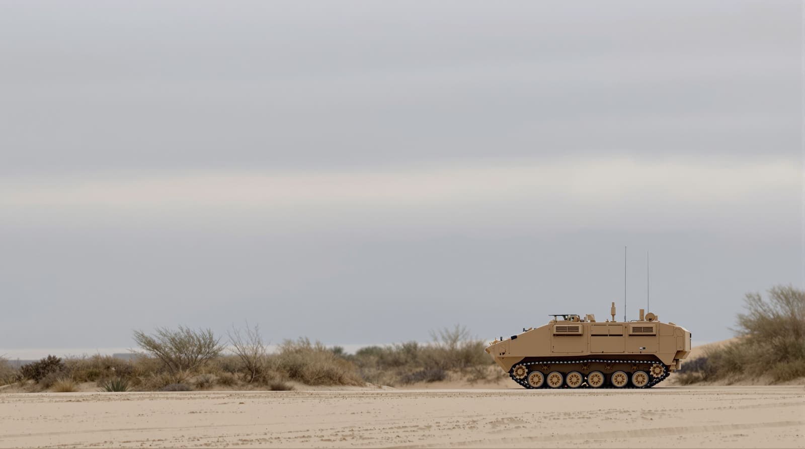 Illustration of a sand-coloured armoured personnel carrier seen from a distance across pale dunes, with the hazed skyline of Gaza City beyond.