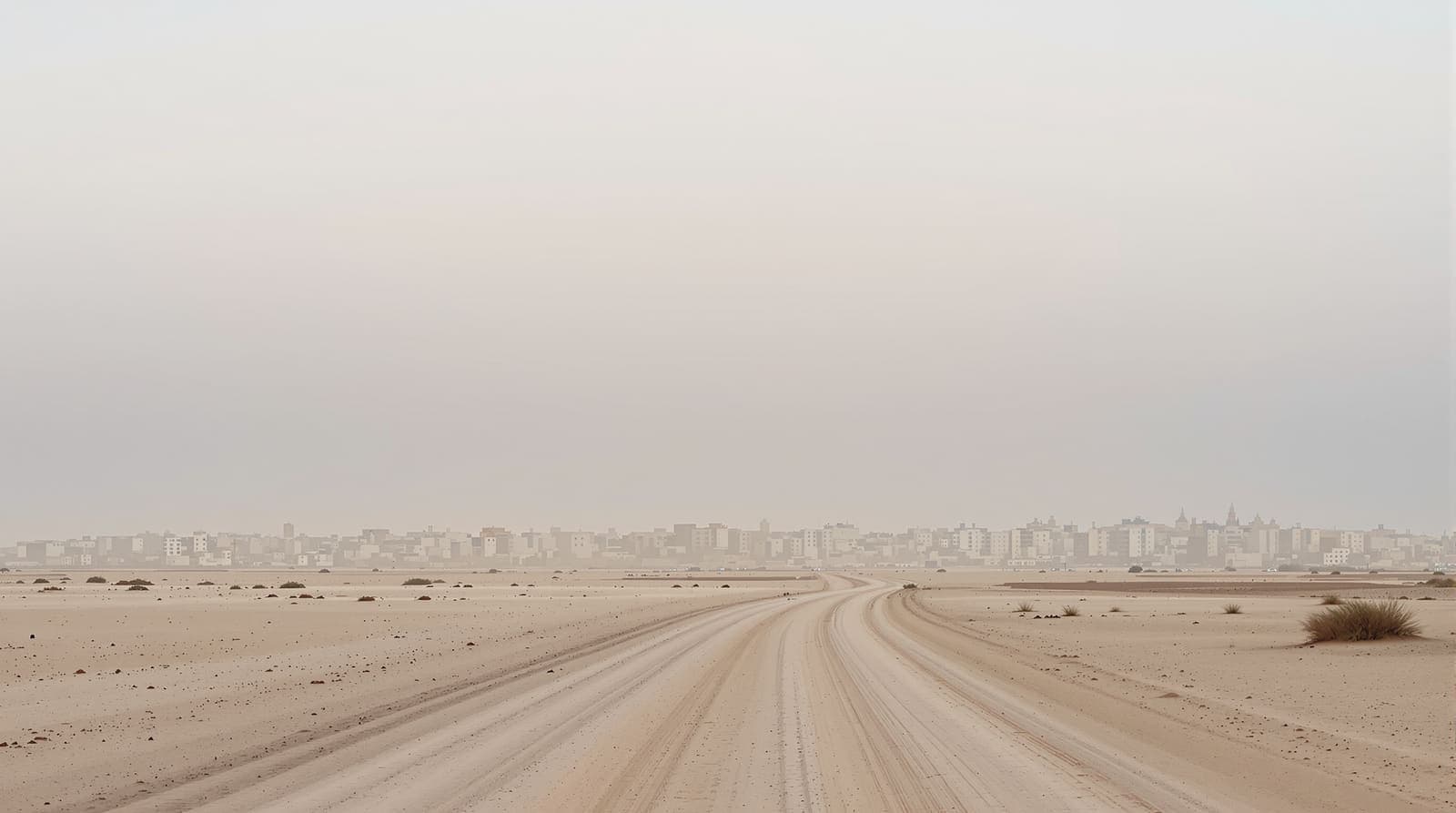 Illustration of the hazy low skyline of Khan Younis in southern Gaza seen across flat sandy ground at dawn