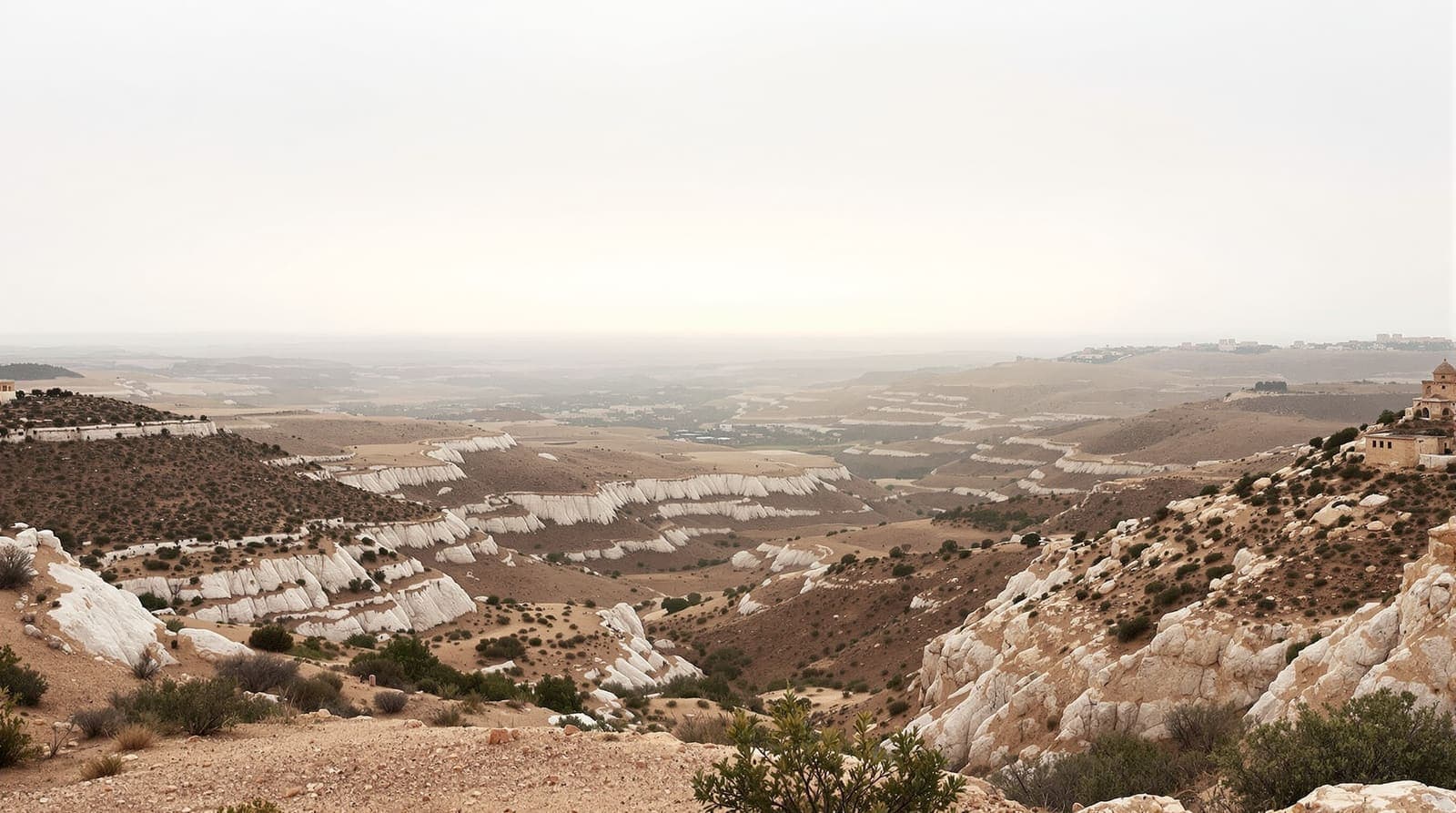 Illustration of hazy southern Lebanese ridgelines and terraced hills seen at dawn from a distant hilltop across the border.