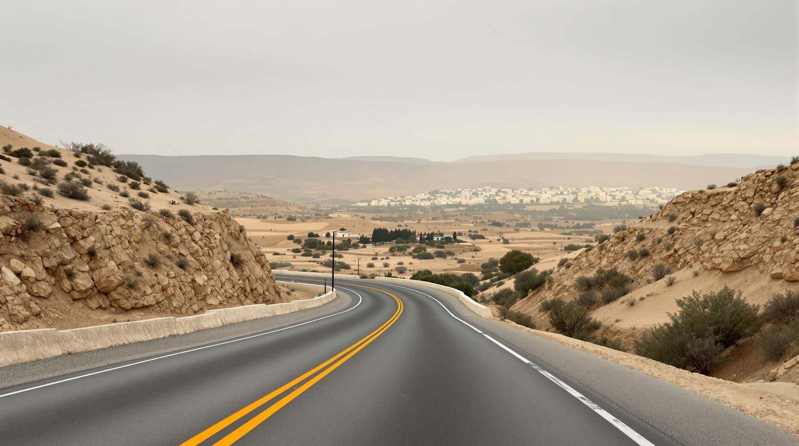 Illustration of an empty highway curving through limestone hills and olive terraces at dawn, with a distant hillside town in haze.