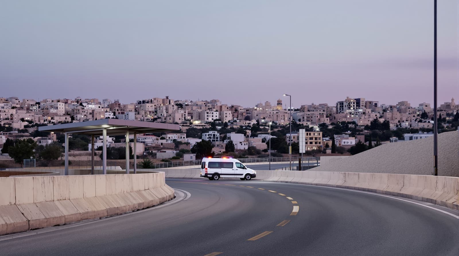Illustration of an empty road leading to a concrete checkpoint on the Jerusalem hillside at dusk, with a parked ambulance.