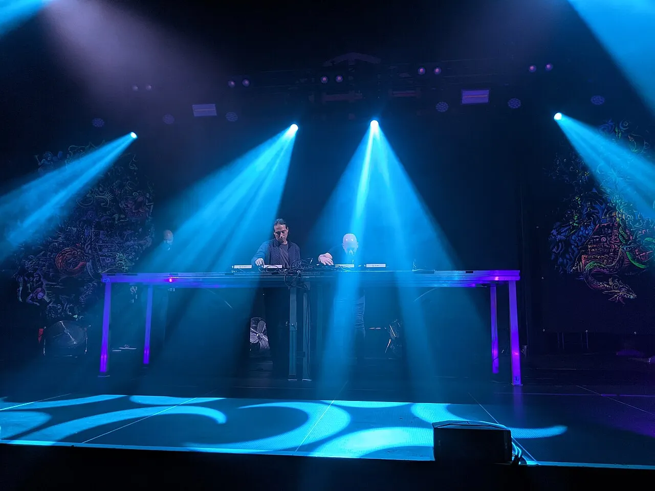 Infected Mushroom playing a DJ set under blue stage lights in Tampere, Finland, October 2024