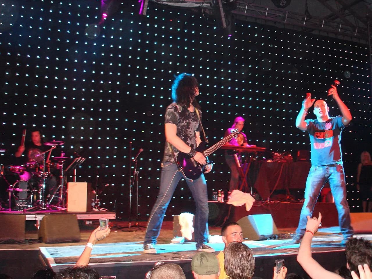 Infected Mushroom live at Coachella, 2007, with a guitarist and the crowd's hands in the air