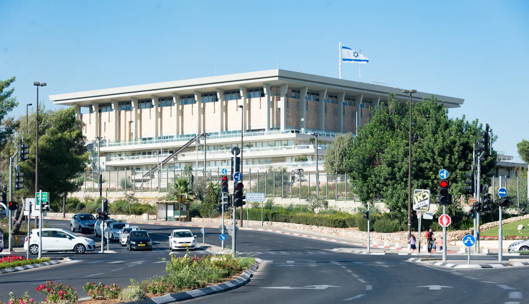 The Knesset in Jerusalem seen from the road below it, the national flag flying over the roof
