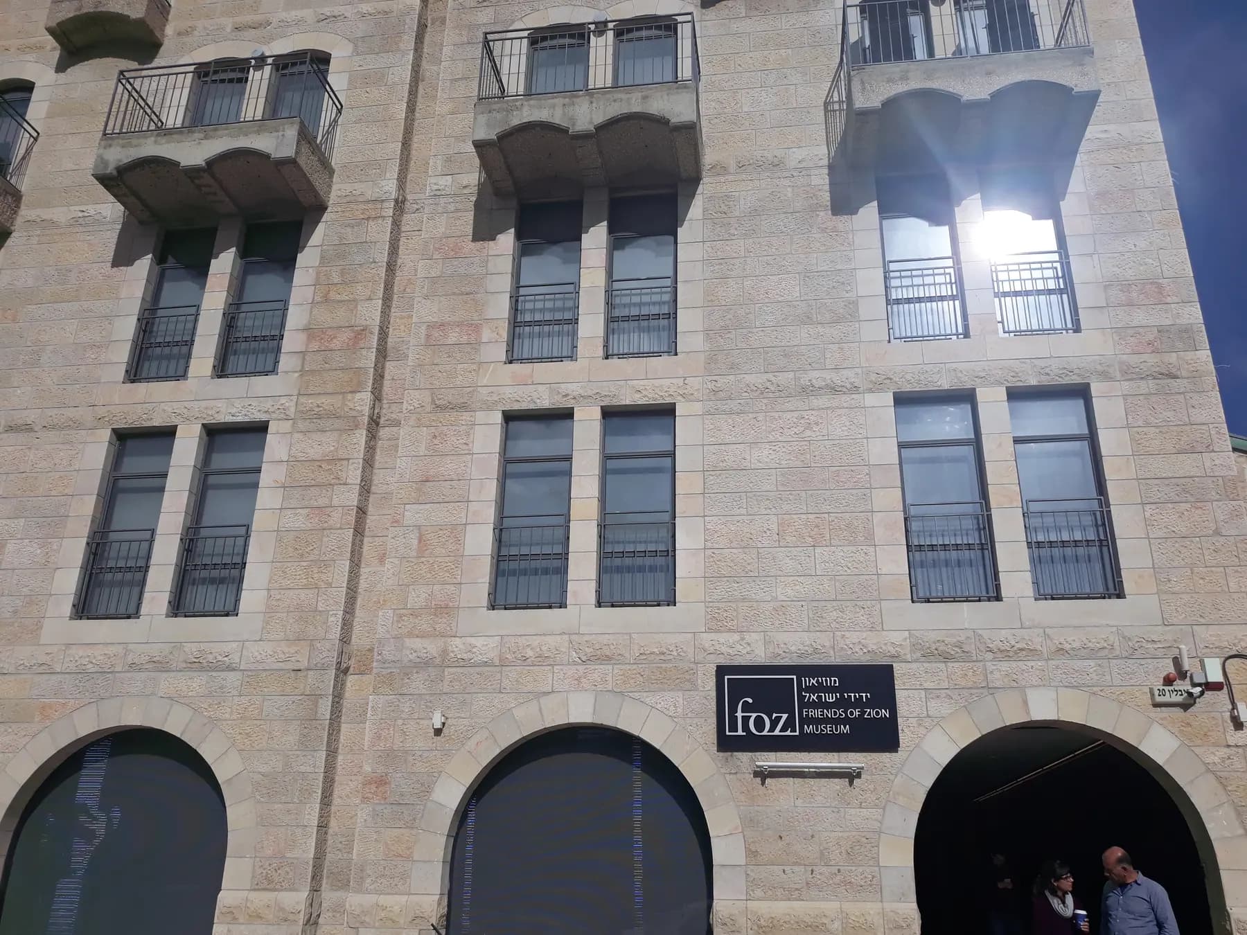 The stone front of the Friends of Zion Museum, with the FOZ sign beside its door