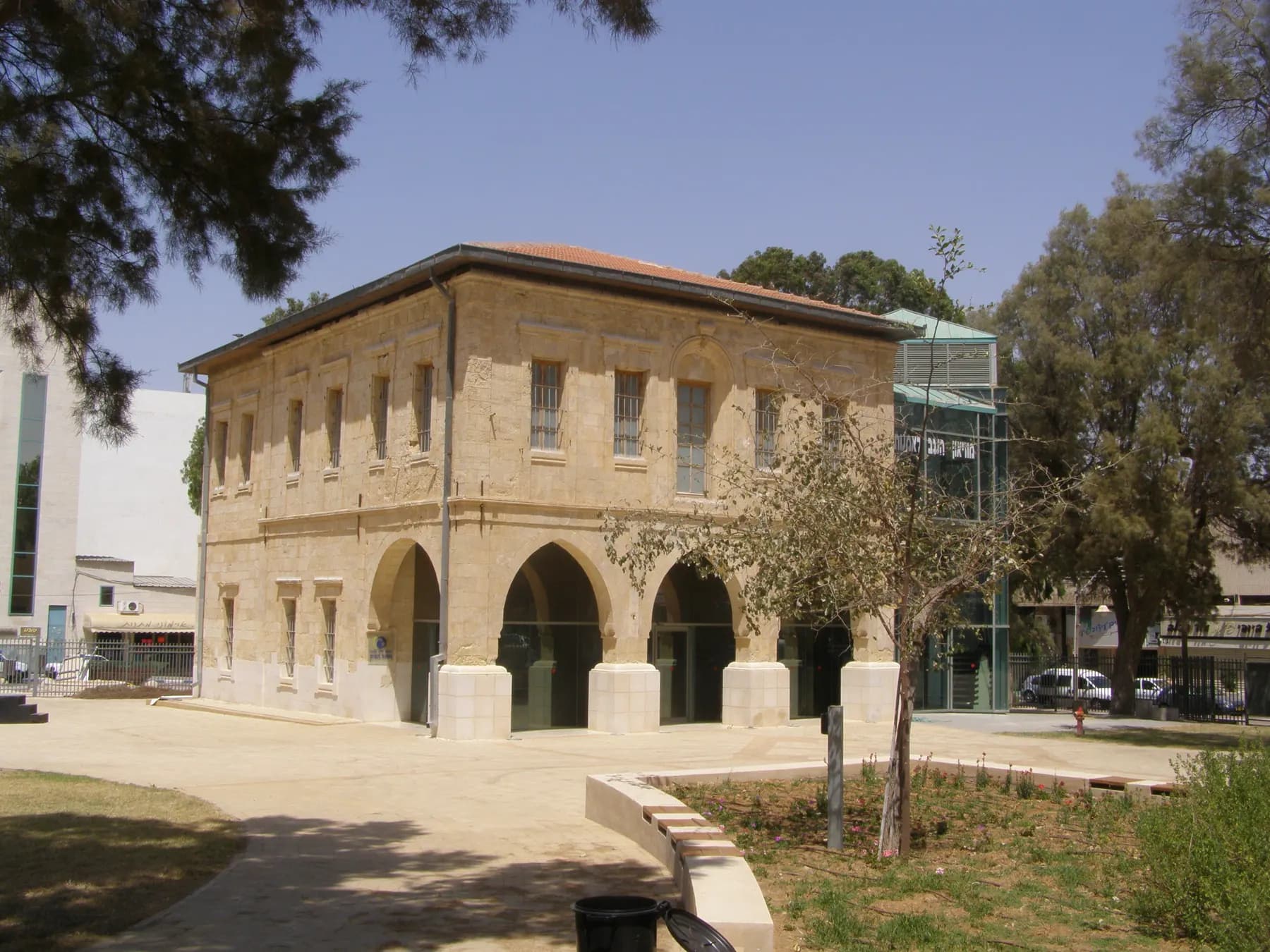 The arched Ottoman stone building of the Negev Museum of Art in Beer Sheva, among trees