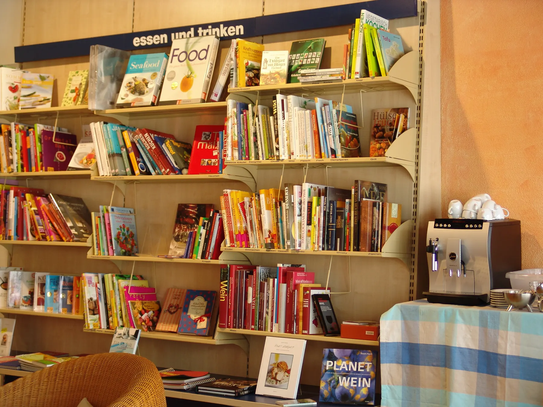 Shelves of books and a table of new titles in a bookshop.
