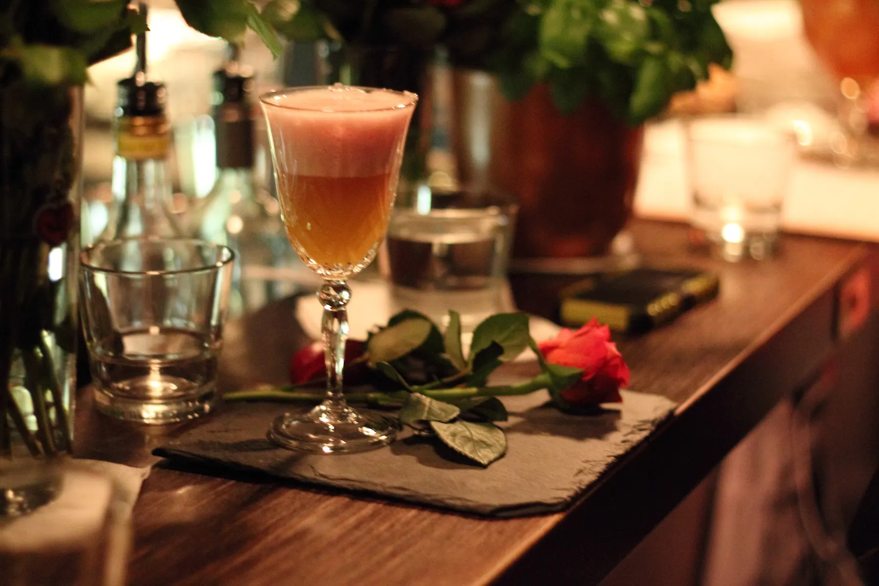 A cocktail on a wooden bar counter