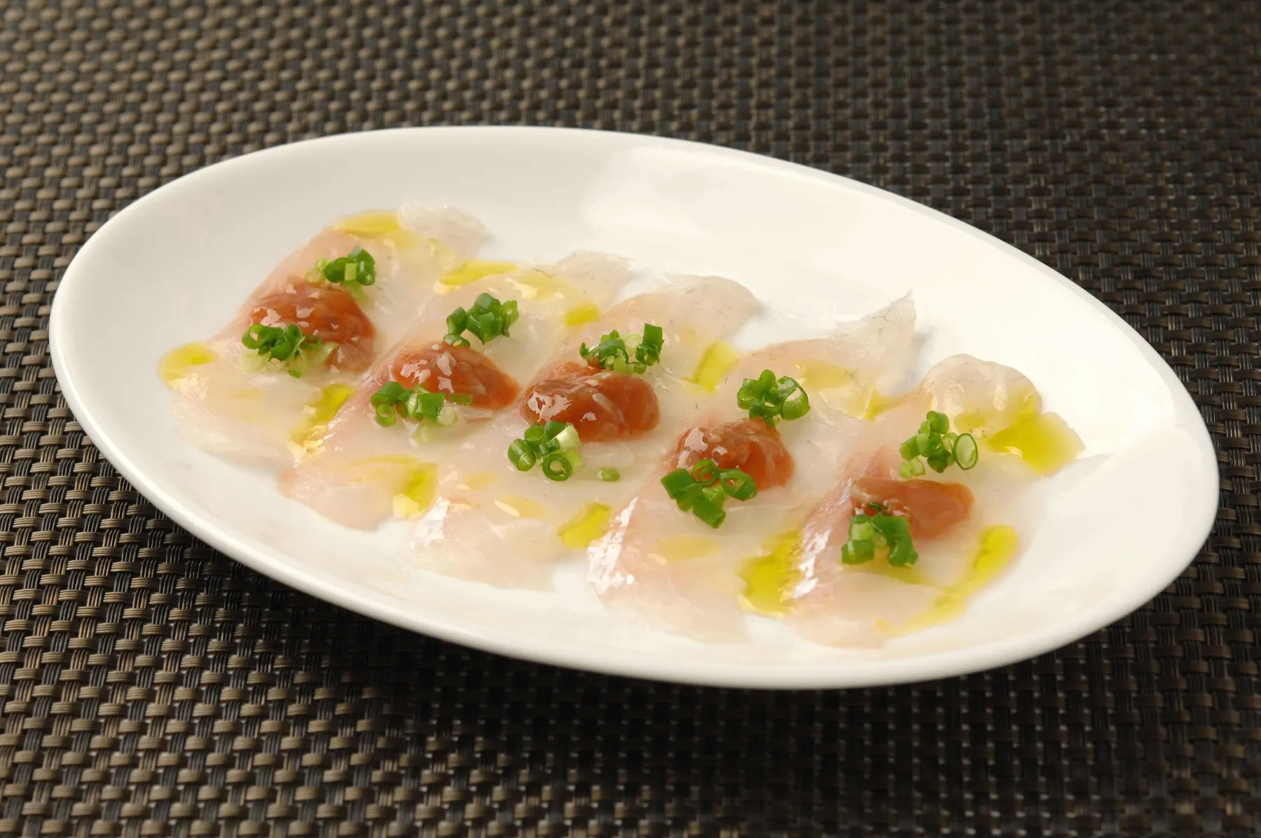 Thin slices of raw white fish dressed with olive oil