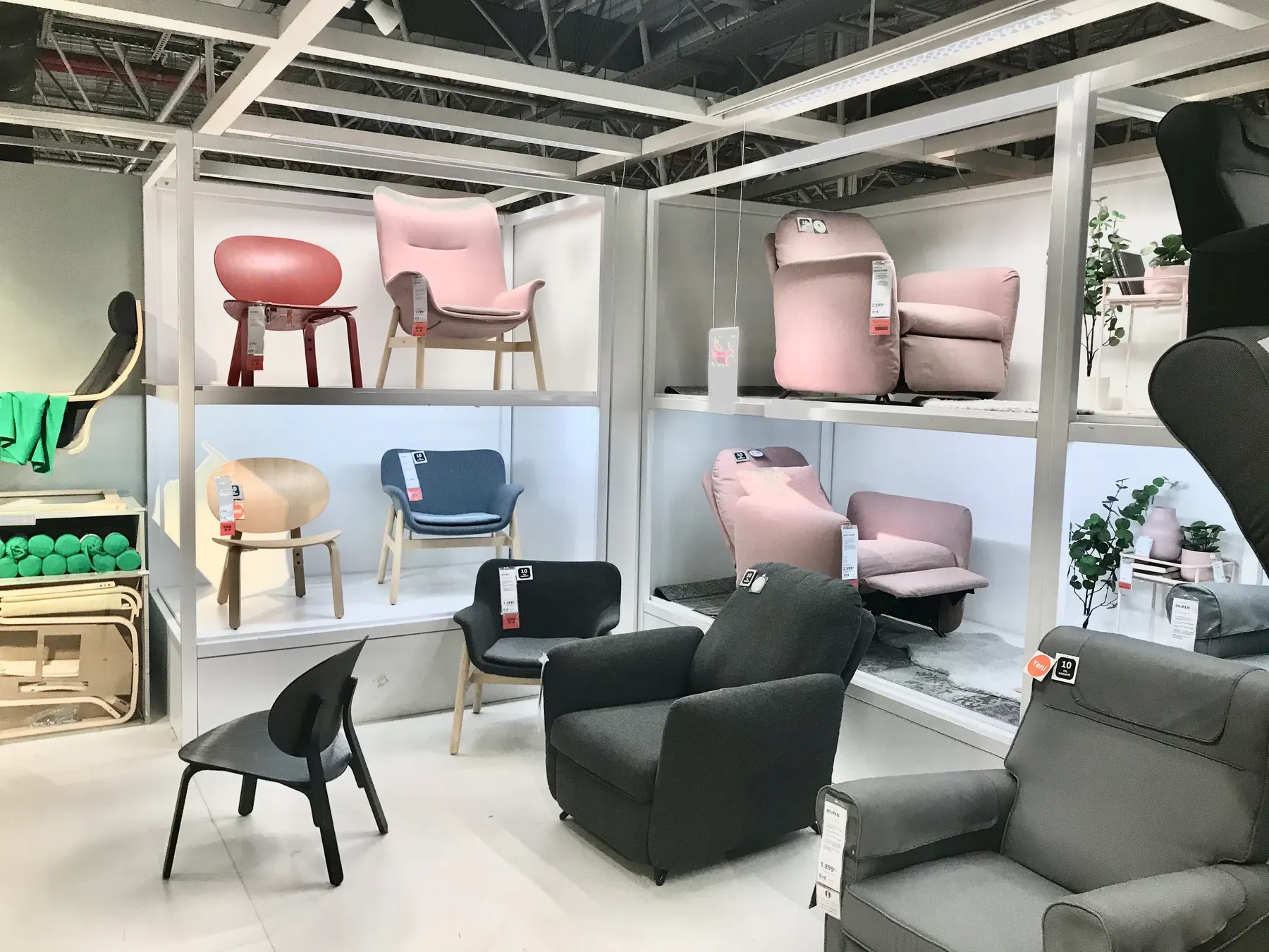 Armchairs and chairs set out on a furniture showroom floor.