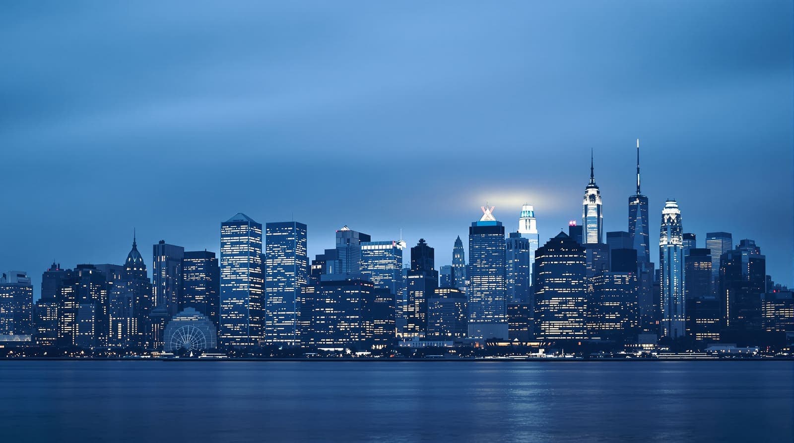 Illustration of the Midtown Manhattan skyline seen from across the water at dusk, towers lit in blue haze.
