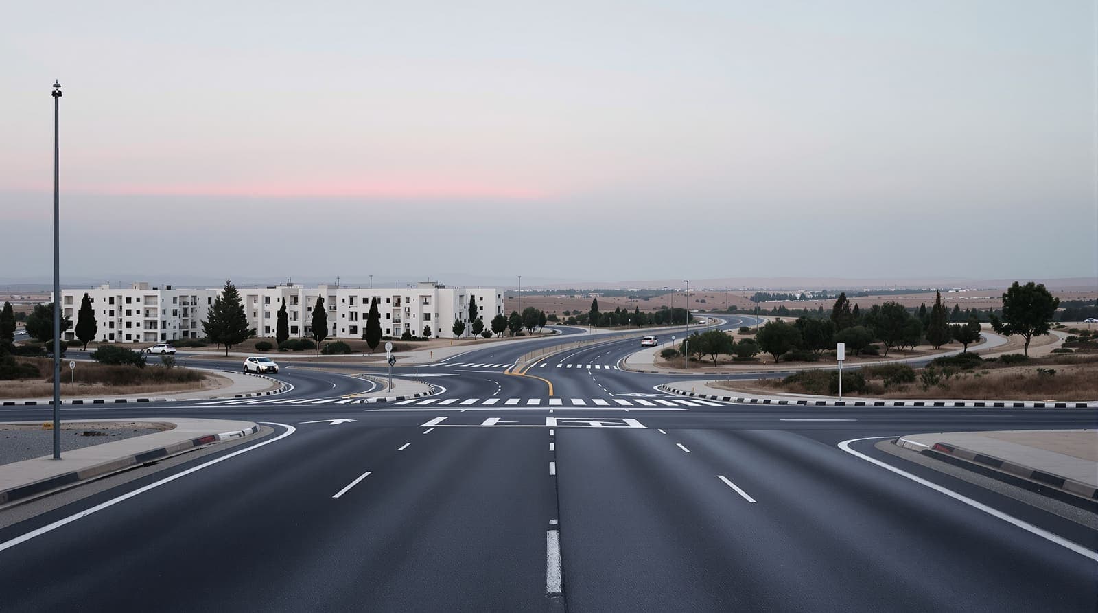Illustration of an empty multi-lane road junction in northern Israel at dawn, lined by pale apartment blocks and eucalyptus trees.
