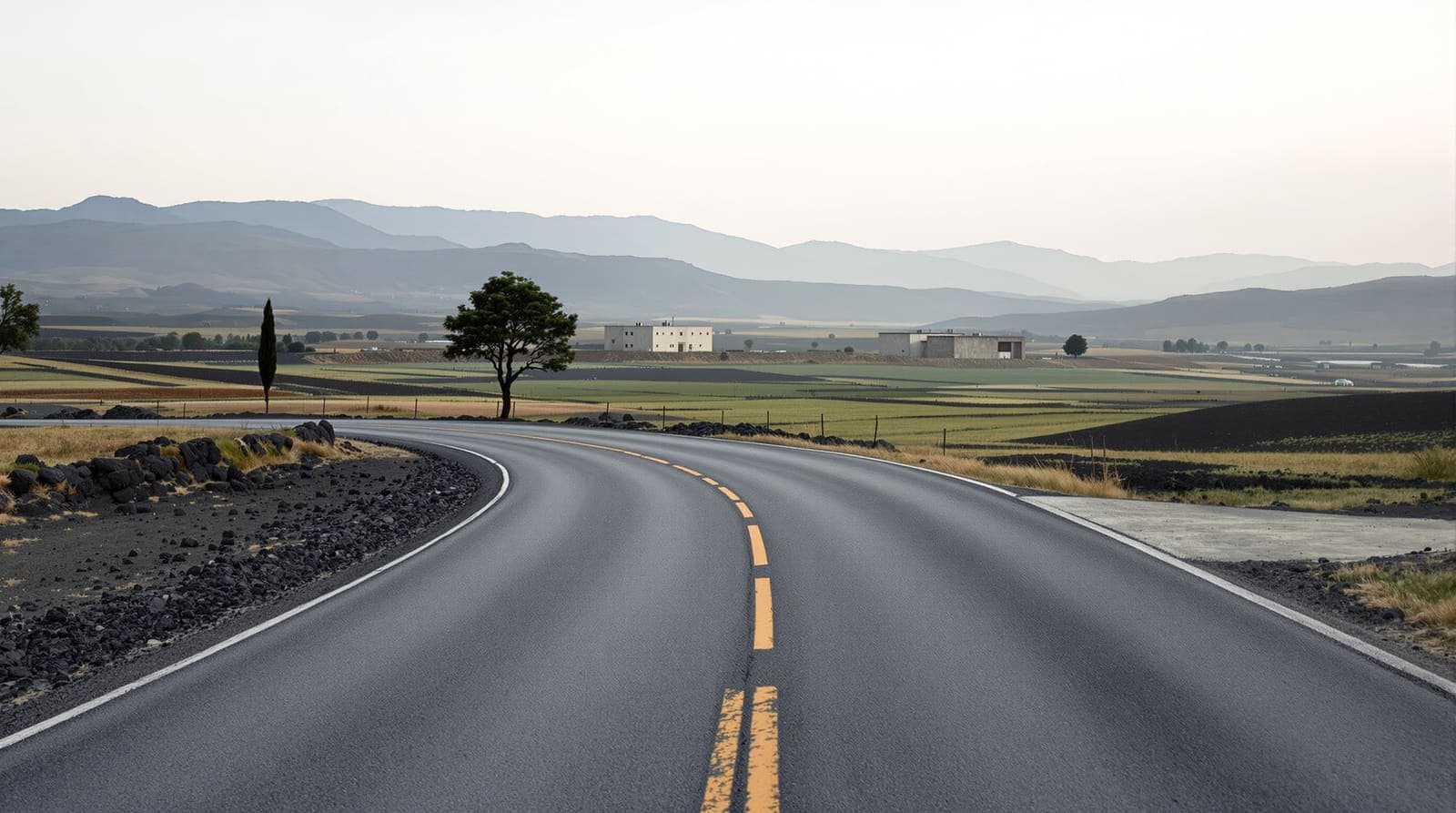 Illustration of an empty rural road and side turning at the edge of a Golan Heights farming community at dawn.