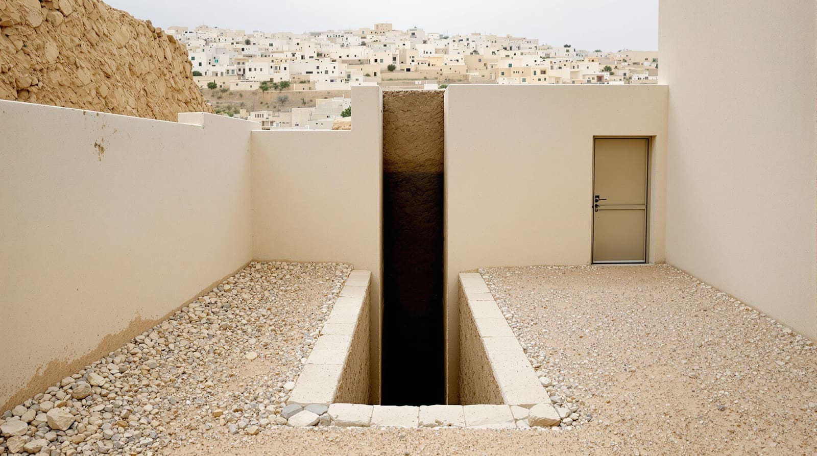Illustration of a narrow shaft dug into earth in a stone courtyard beside a limestone house, with Hebron's hillside buildings in haze beyond.