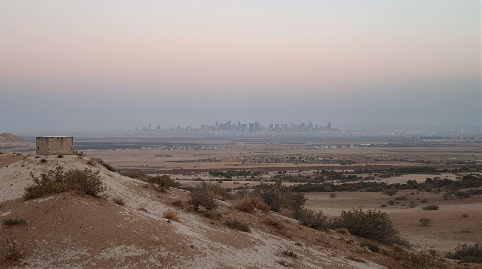 Illustration of a hazy distant Gaza skyline viewed across quiet scrubland at dusk from an Israeli overlook.