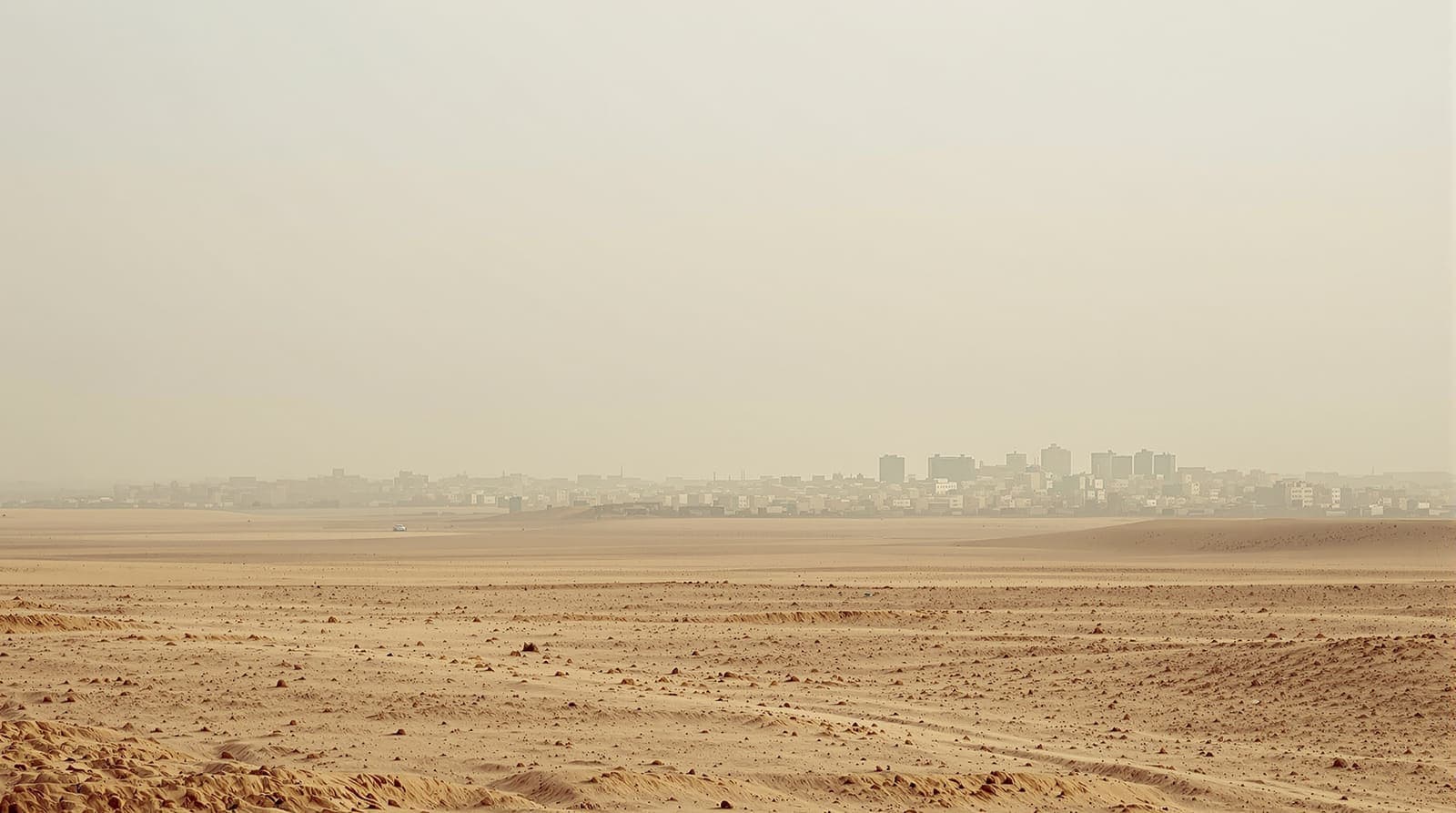 Illustration of a distant southern Gaza skyline in pale haze seen across flat open ground at dawn.