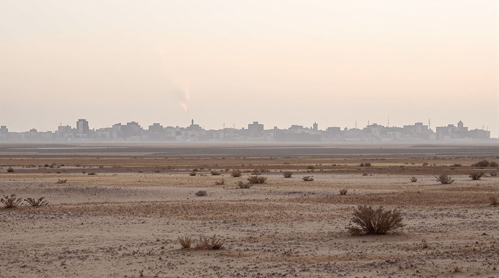 Illustration of the hazy skyline of a southern Gaza town seen across flat sandy farmland at dawn.