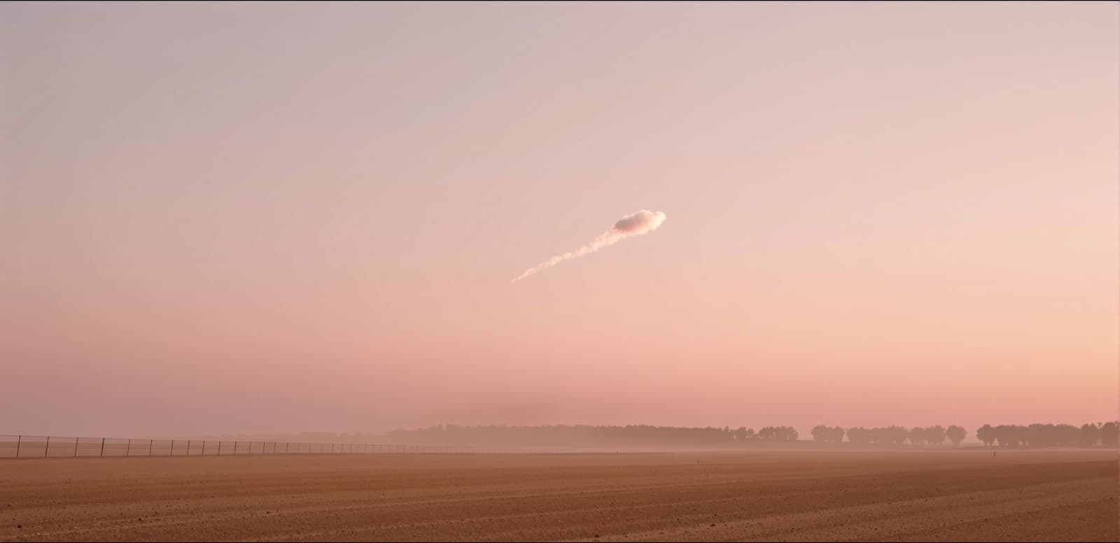 Illustration of a small cloud of white smoke dispersing high in a dawn sky over flat sandy border fields in Israel's western Negev.