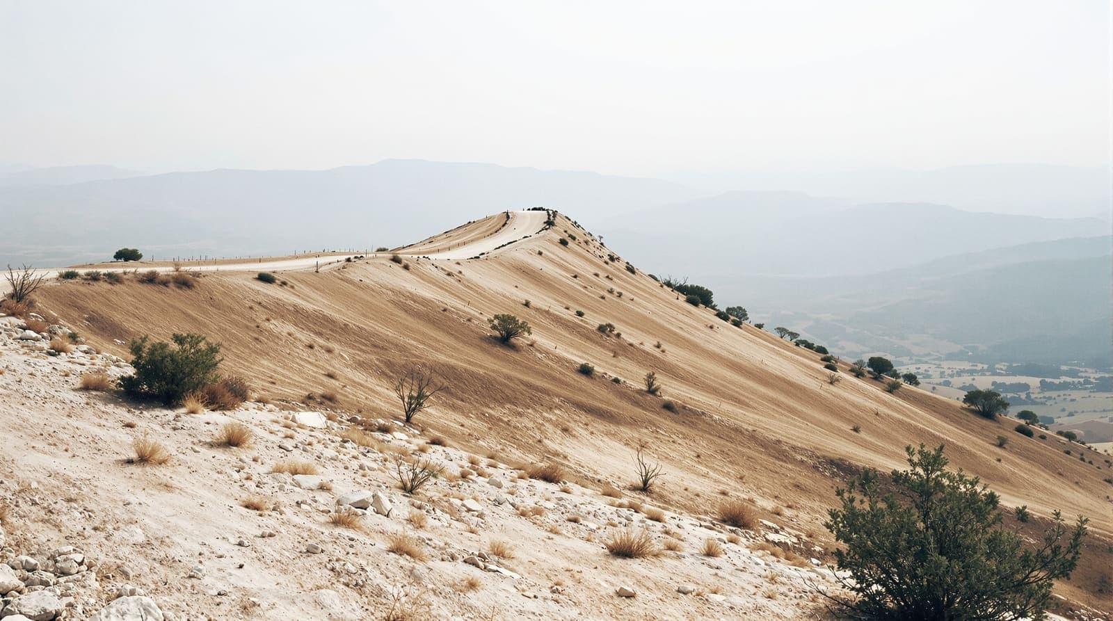 Illustration of a bare limestone ridge and dirt track in southern Lebanon at dawn, with hazy valleys and layered ridgelines behind.