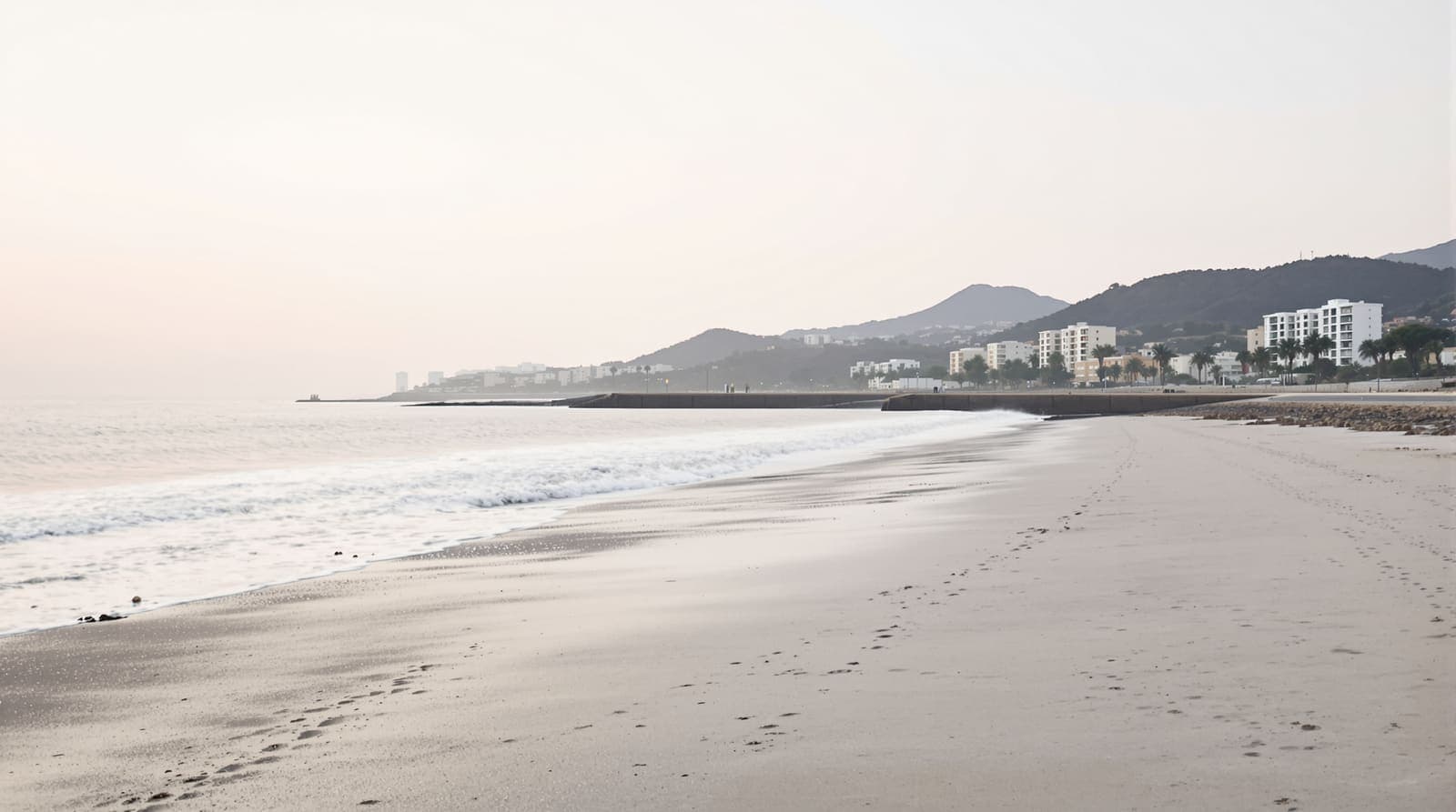 Illustration of an empty Haifa beach at dawn, calm sea and a stone breakwater below the hazed slopes of Mount Carmel.