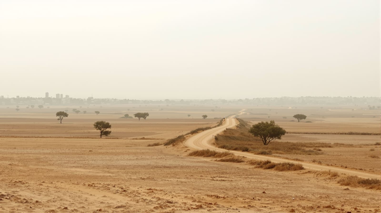 Illustration of a hazed distant skyline near the Gaza boundary at dawn, shown as a quiet setting.