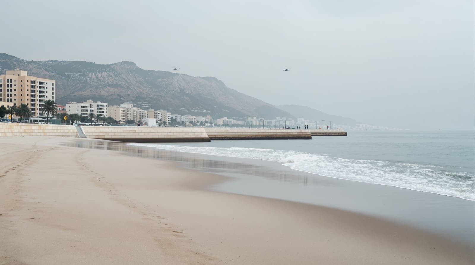 Illustration of an empty Haifa beach at dawn with calm sea, a stone breakwater and Mount Carmel hazy behind the shoreline.