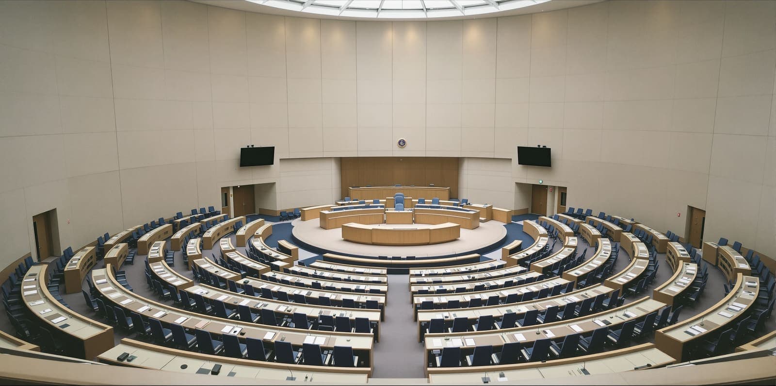 Illustration of the empty Knesset plenum chamber in Jerusalem, seen from the public gallery in soft daylight.