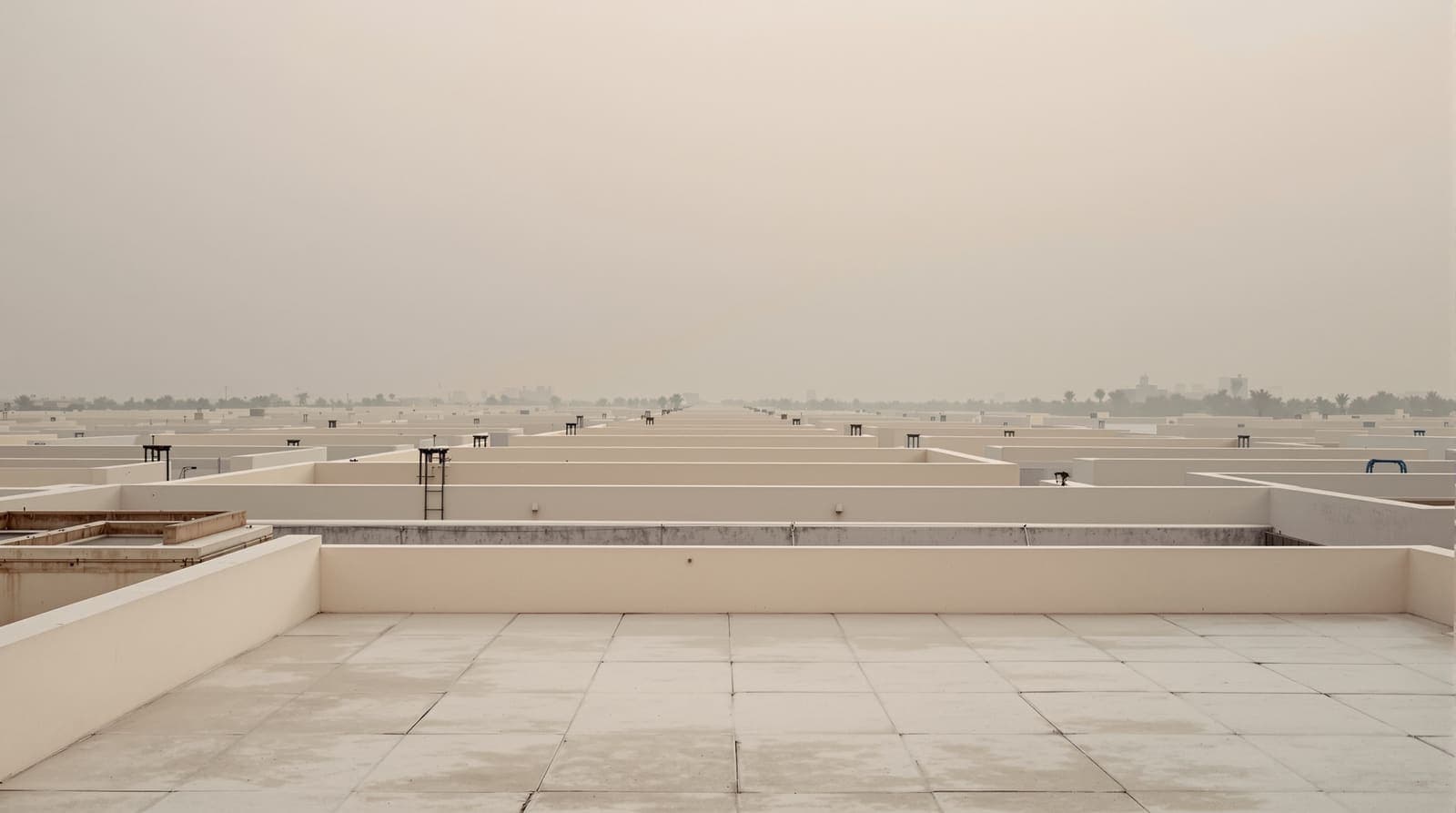 Illustration of flat concrete rooftops stretching across Khan Yunis under a hazy, overcast dawn sky