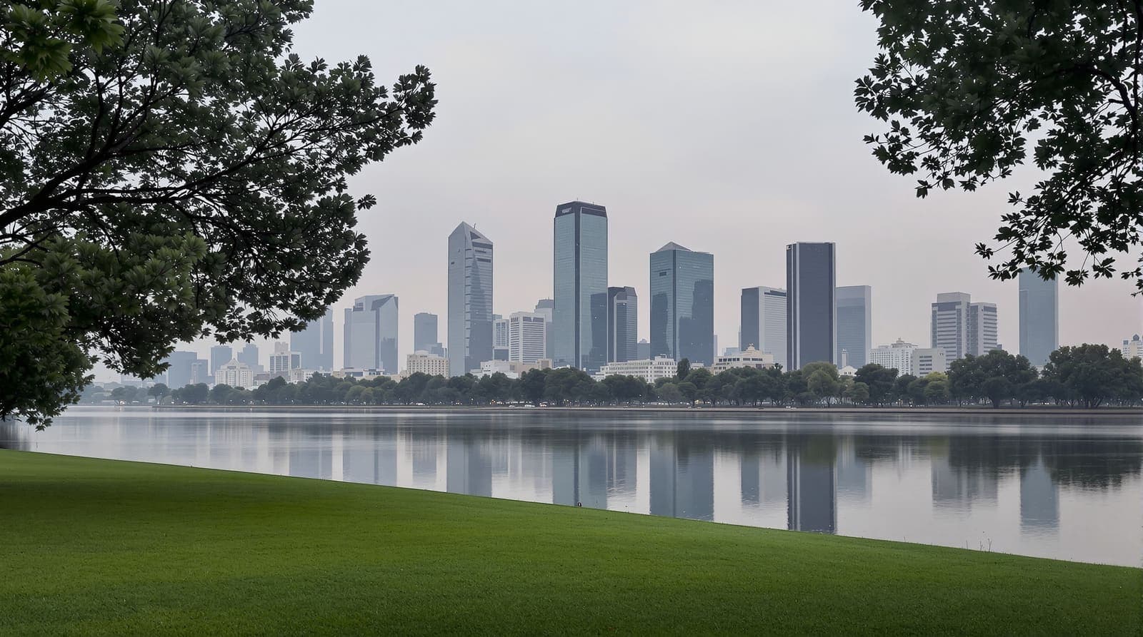Illustration of the Tel Aviv business district skyline seen in hazy silhouette across a park river at dusk.