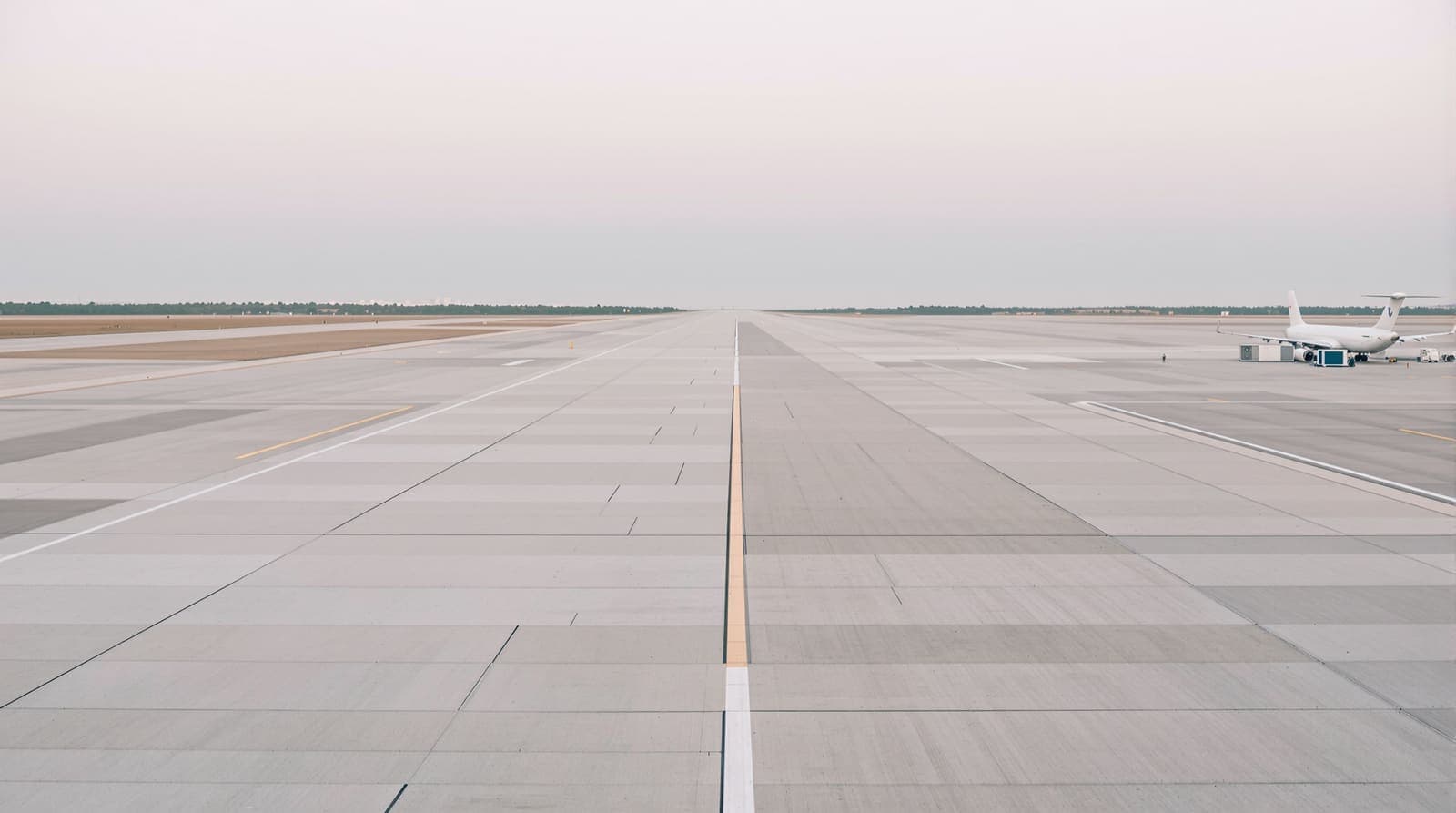 Illustration of the runway and terminal at Ben Gurion Airport at dawn, with a distant parked airliner under a soft overcast sky.