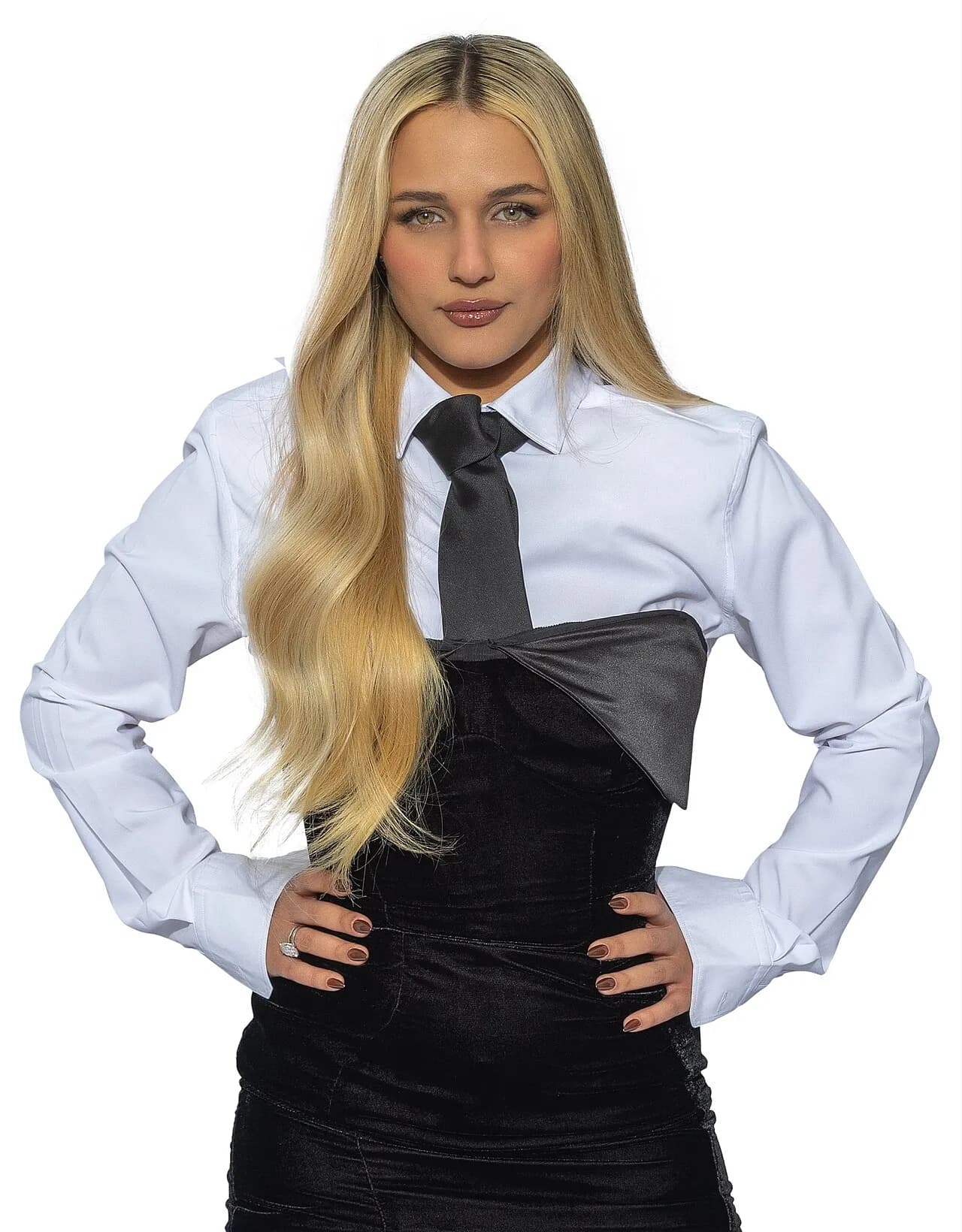Eden Ben Zaken in a white shirt and tie, hands on her hips, 2024