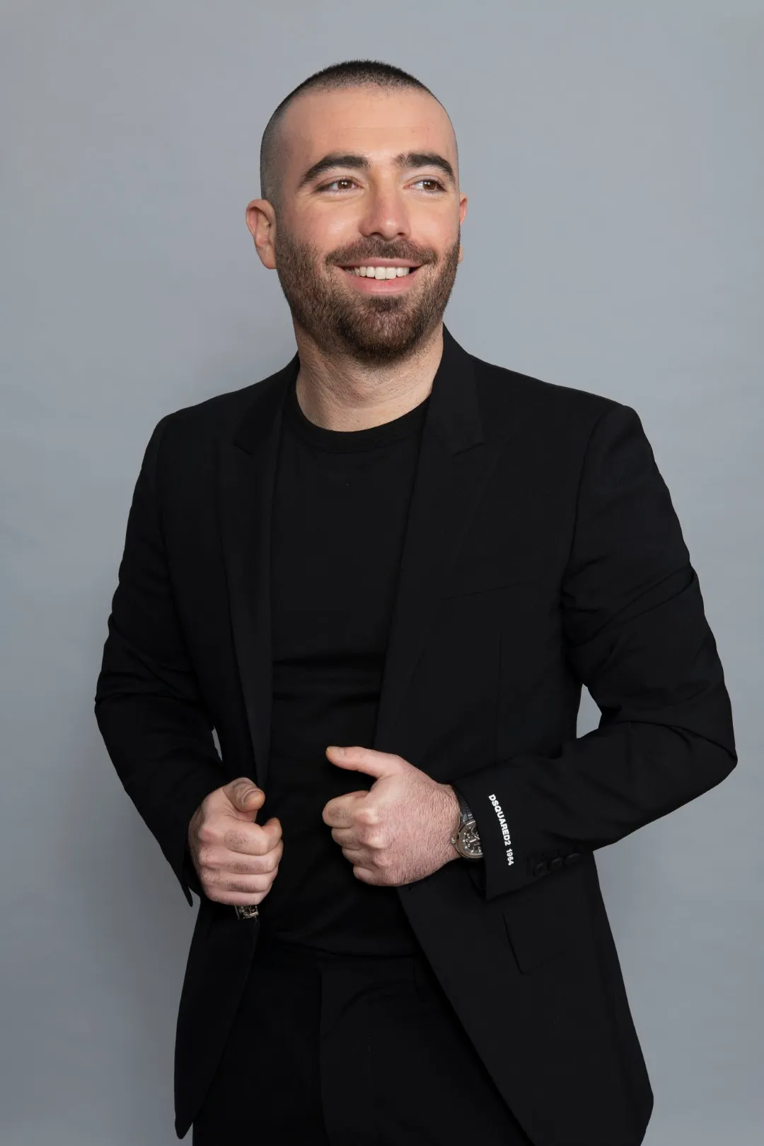 Omer Adam in a black jacket, smiling, 2020