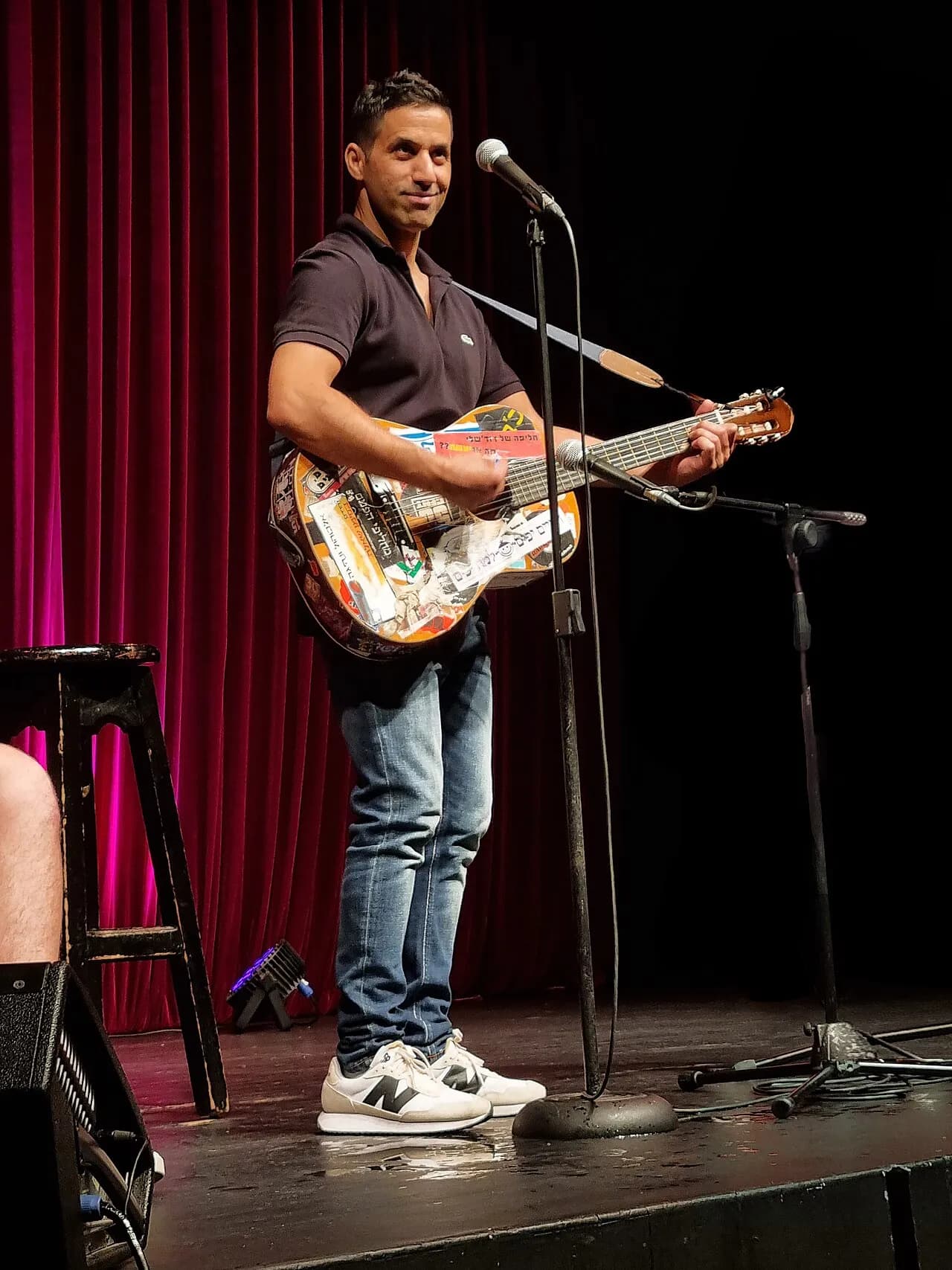 Shahar Hason playing a guitar on stage, 2021