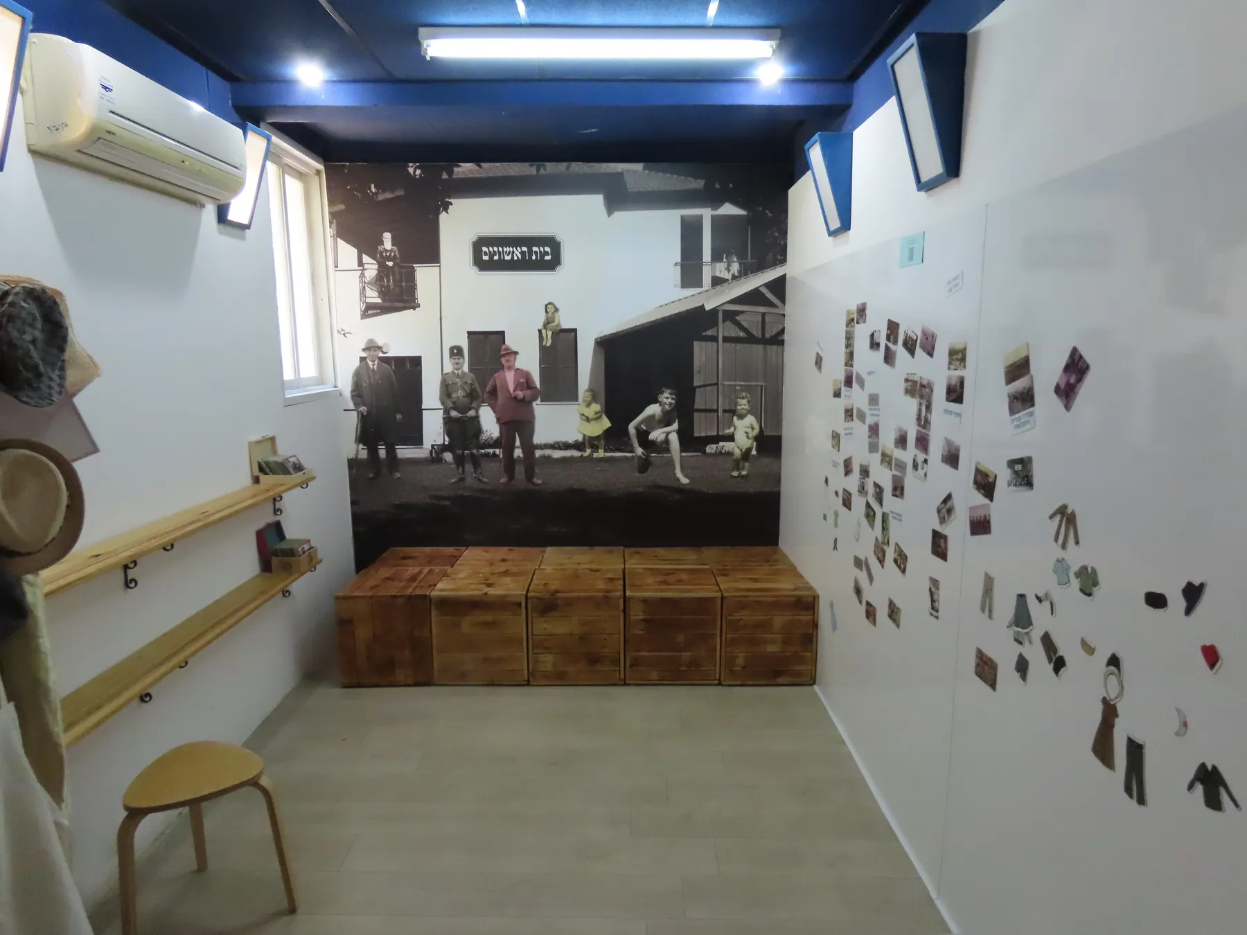 A room inside Beit Rishonim in Herzliya, with old photographs pinned along a white wall