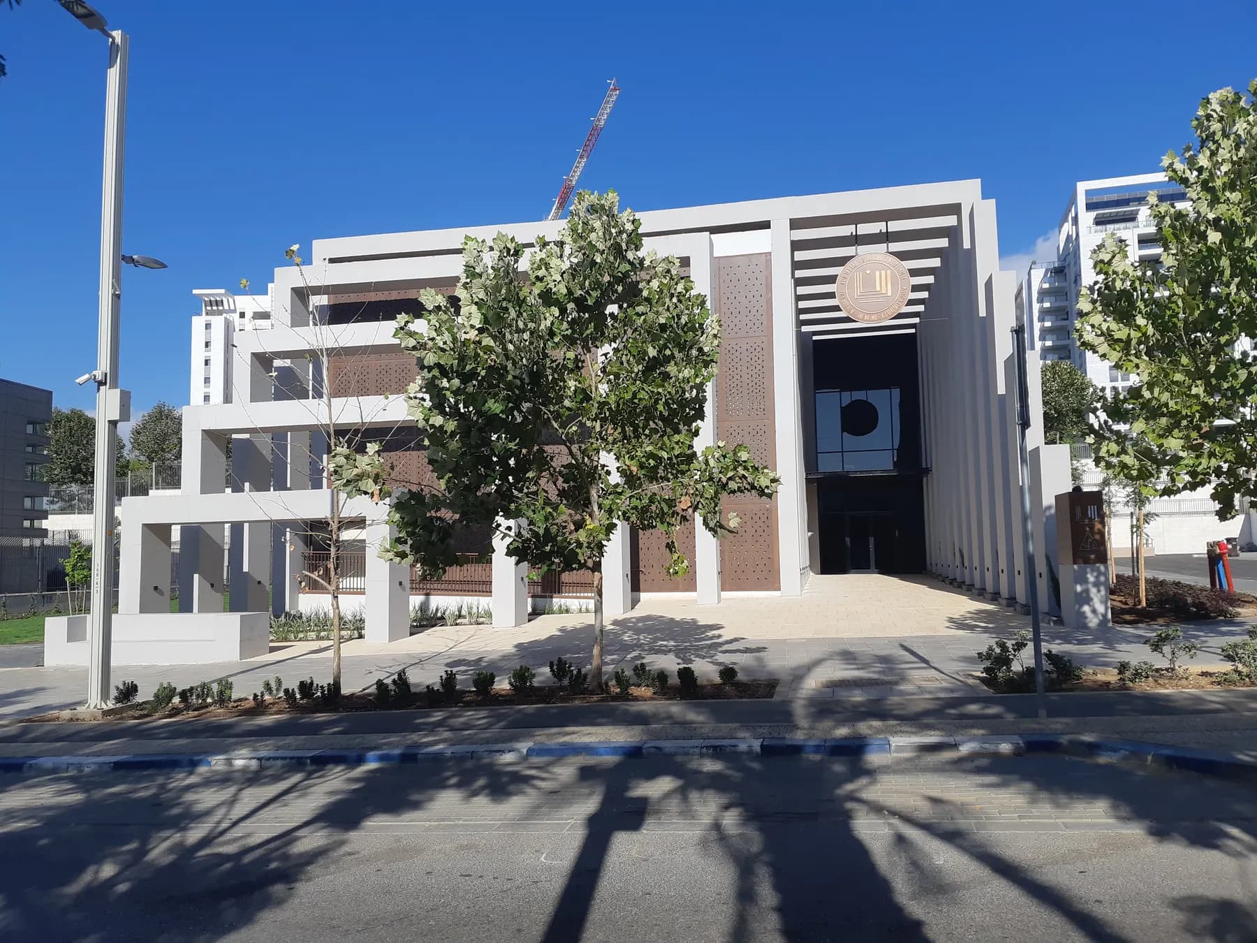 The modern white building of the Hasmonean heritage museum in Modi'in, behind young trees