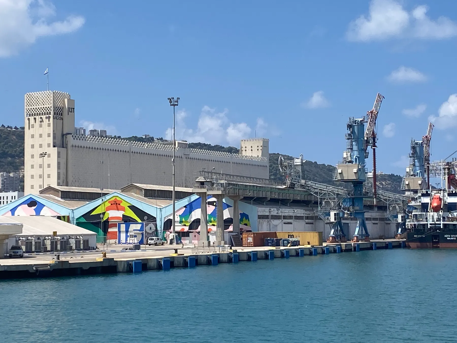 The port of Haifa by the water, with the Dagon grain silo and the cranes
