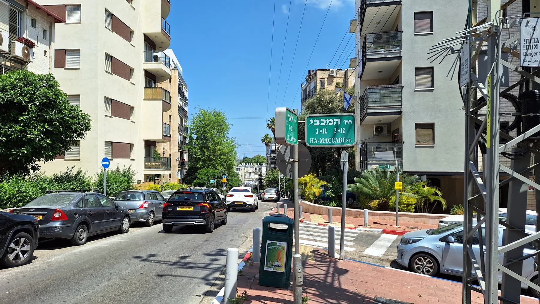 HaMaccabi Street in Ramat Gan, with apartment buildings, parked cars and a pedestrian crossing.