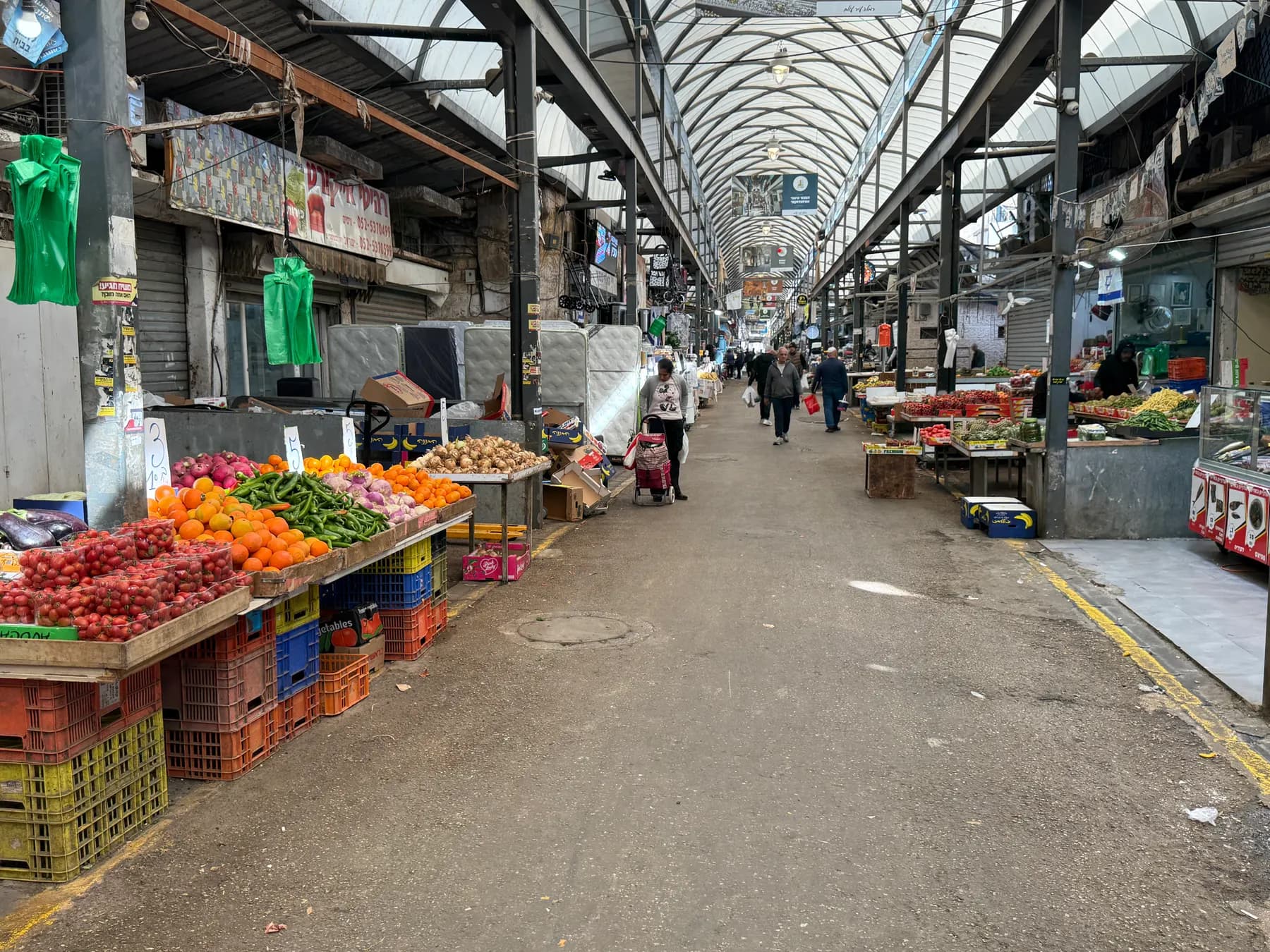 The covered market in Ramla, with fruit and vegetable stalls along a central aisle.