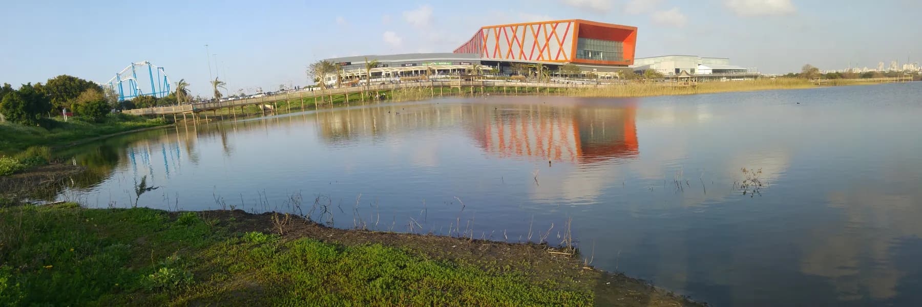 The lake in Rishon LeZion's Lake Park, with the Yes Planet building reflected in the water