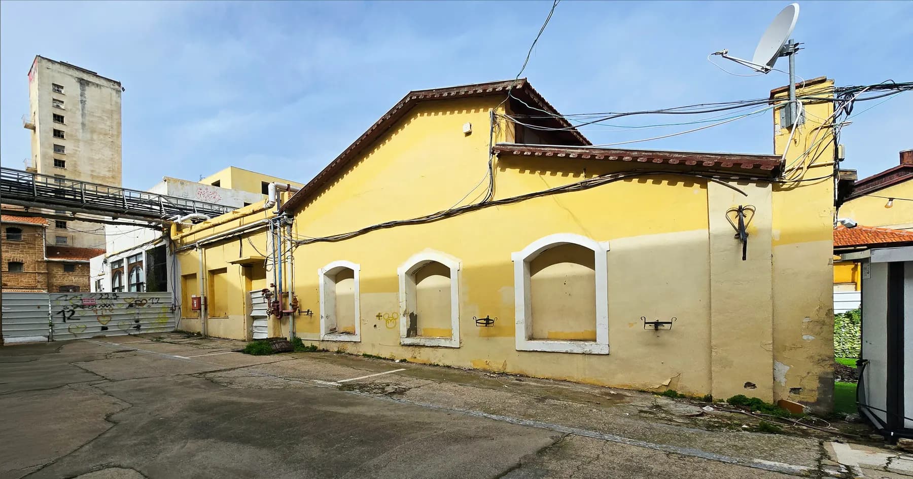 A long yellow building with arched windows in the old Carmel winery complex in Rishon LeZion