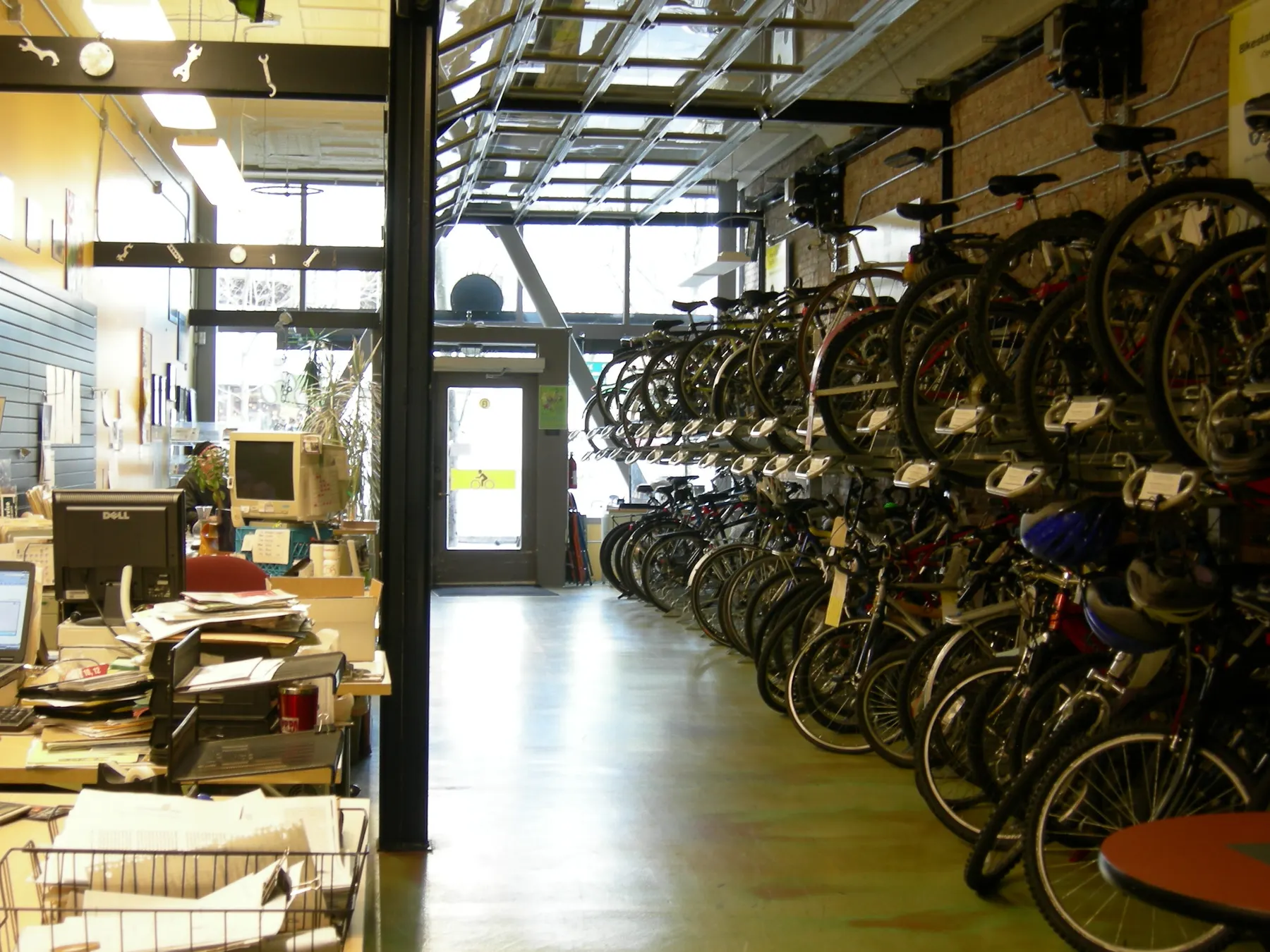 Bicycles lined up in rows inside a bike shop.