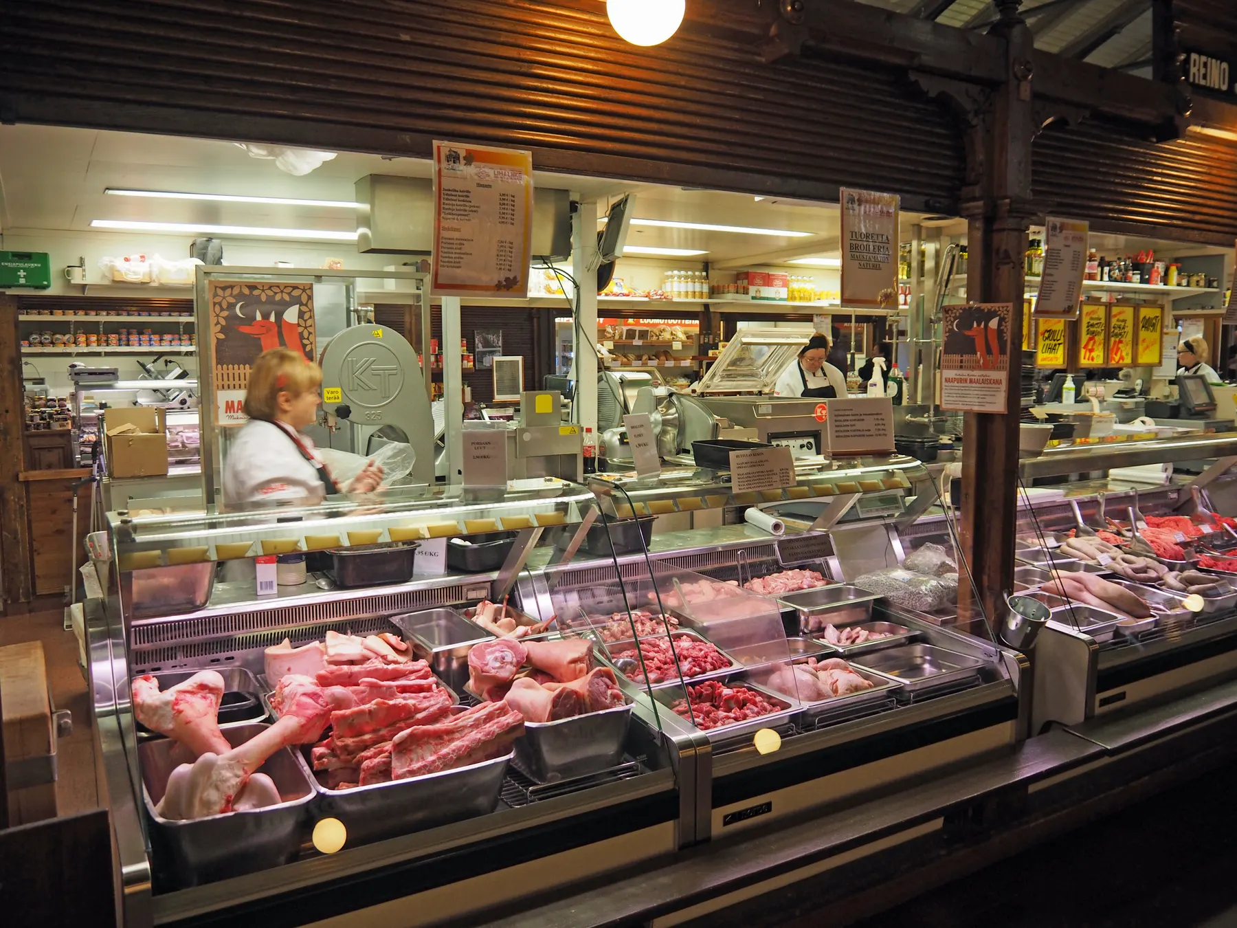 Cuts of meat in a butcher's counter at a market hall.