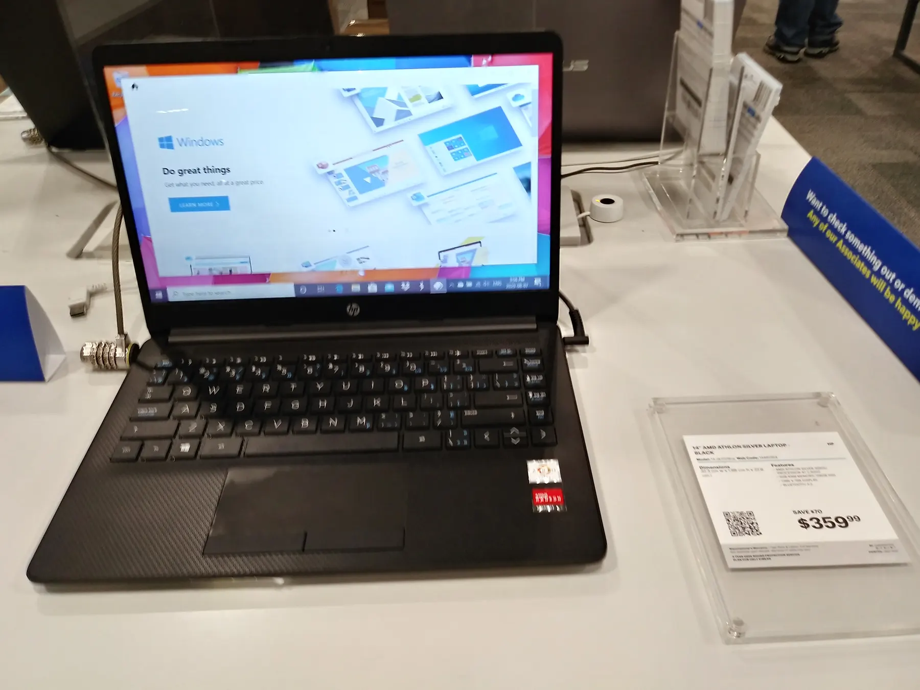A laptop on a display table in a computer shop.