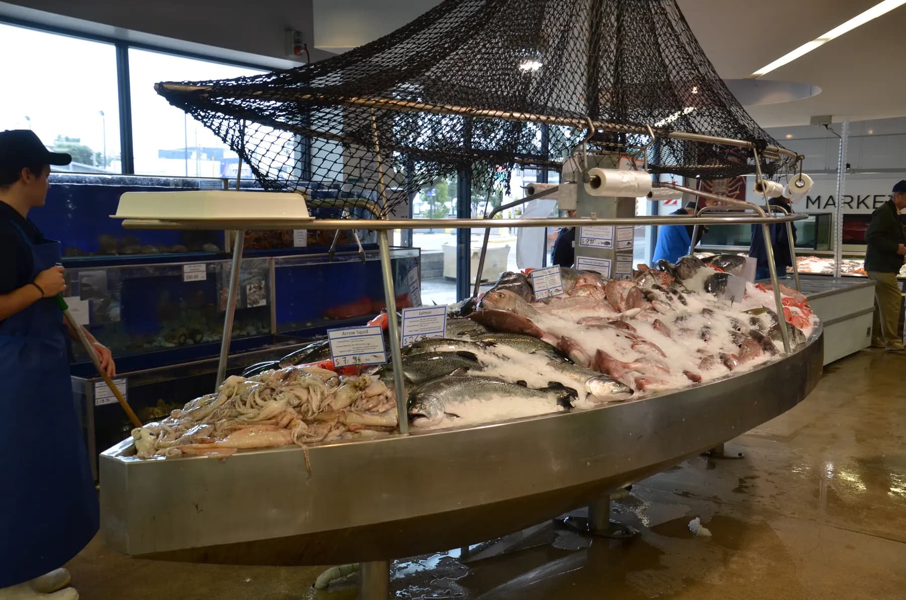 Whole fresh fish laid on ice at a fishmonger's stall