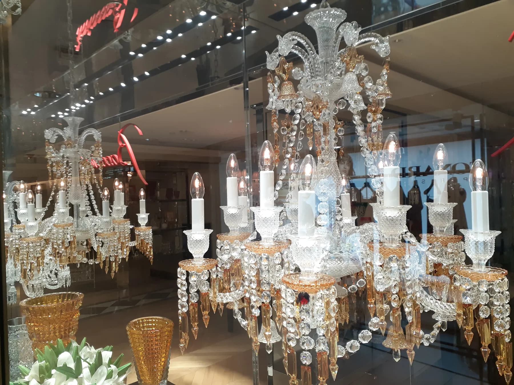 Crystal chandeliers hanging in a lighting shop.