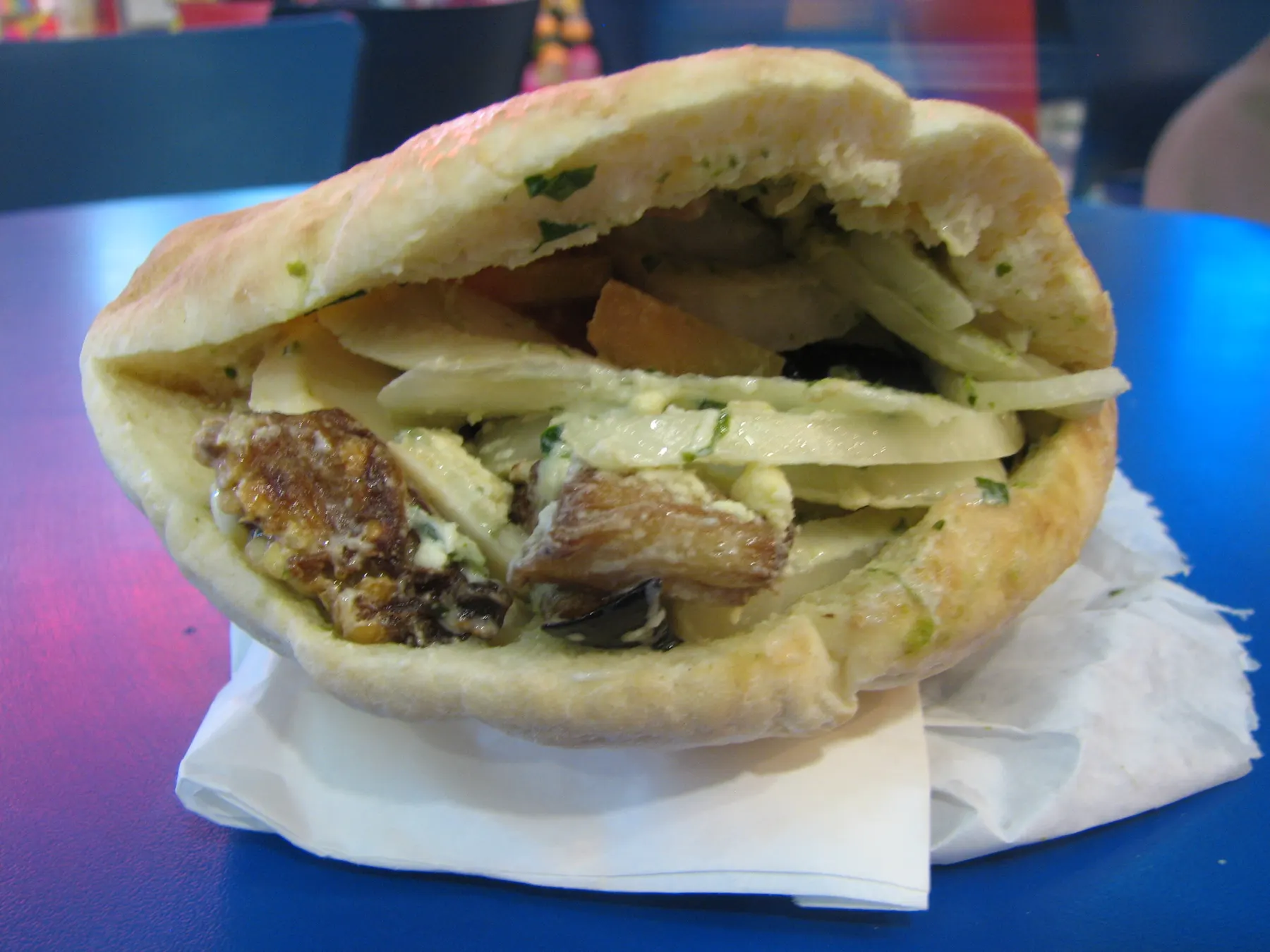 A sabich in a pita: fried aubergine, hard-boiled egg, salad and tahini