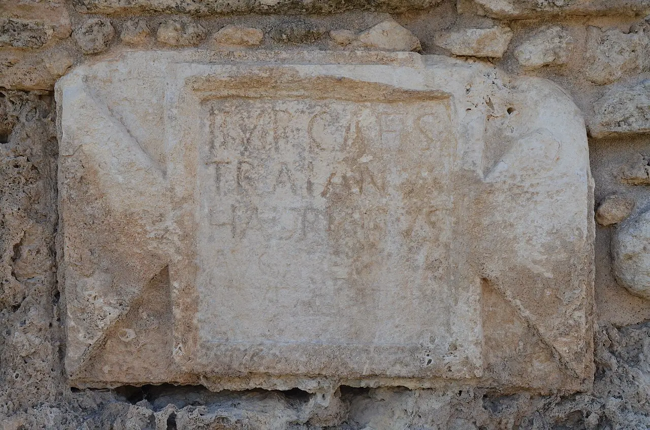 A stone tablet with a Latin inscription naming the emperor Hadrian, set in the high-level aqueduct at Beit Hananya
