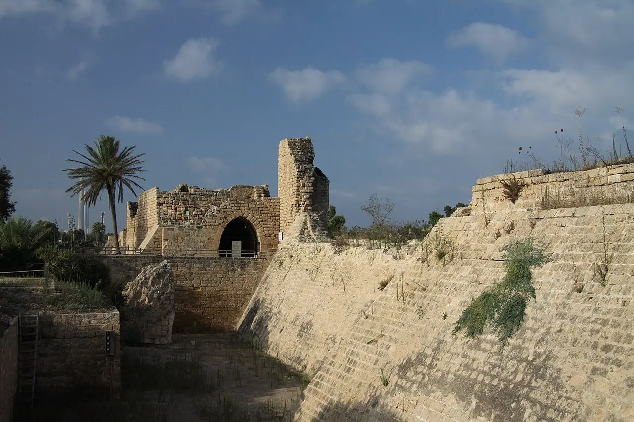 A gate tower and the sloping Crusader wall above the dry moat at Caesarea