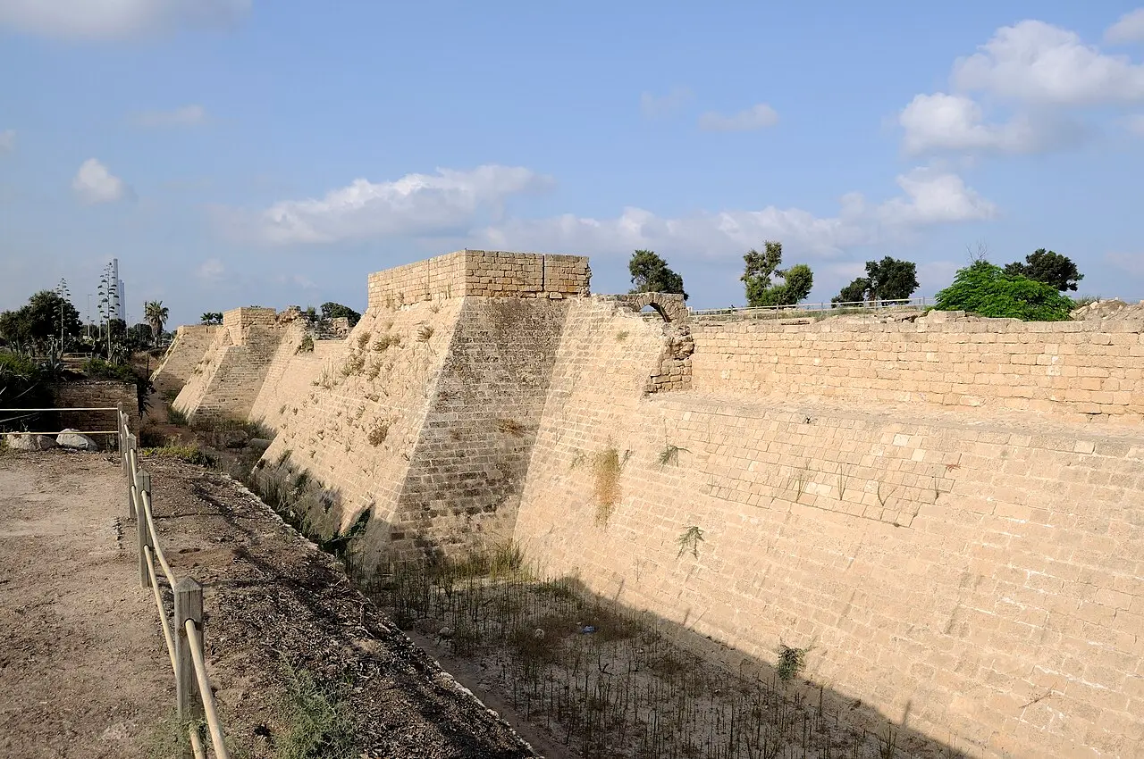 The dry moat and the sloping stone glacis of the Crusader walls at Caesarea
