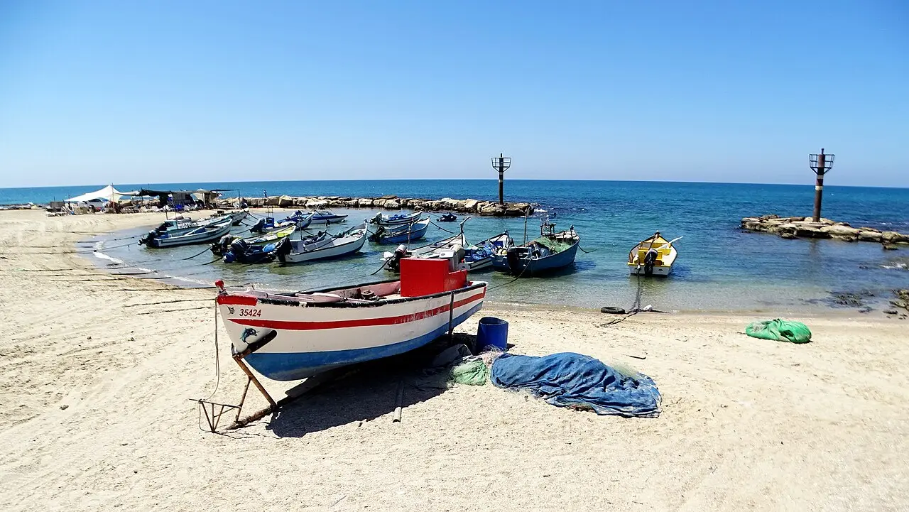 Boats drawn up on the sand at the fishermen's bay, Jisr az-Zarqa